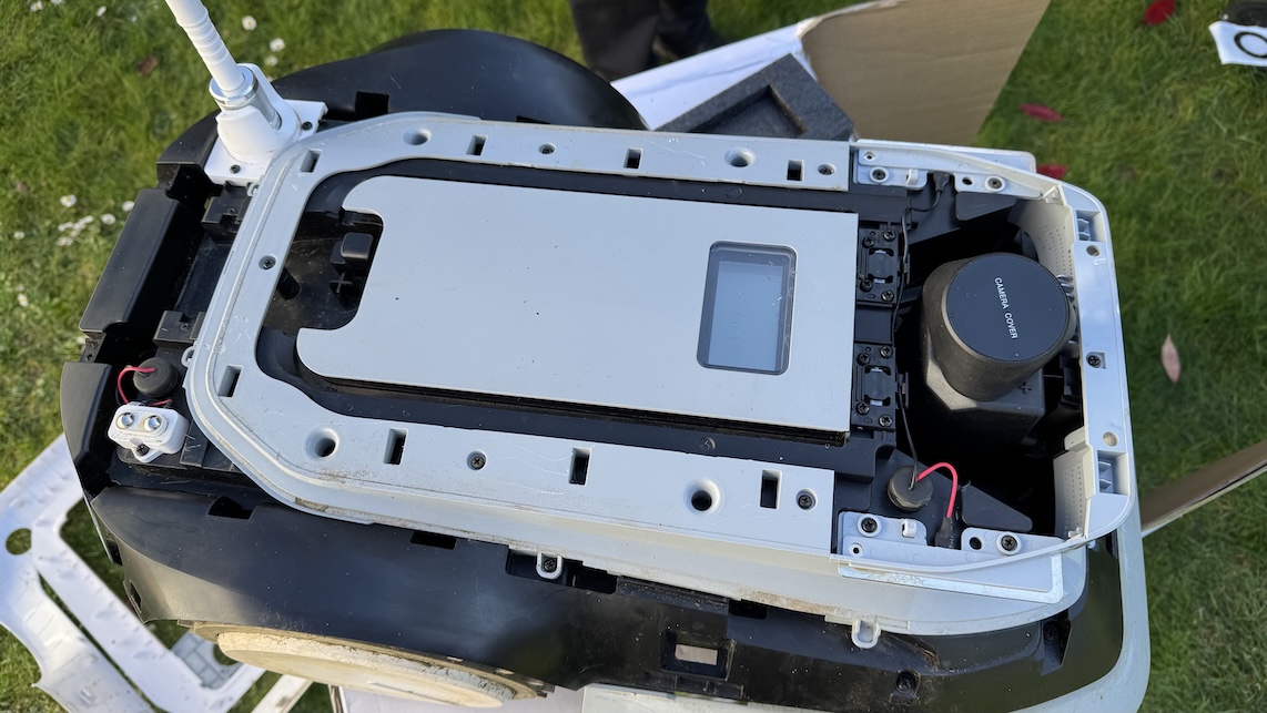 Opened Ecovacs Goat G1 lawn mower showing internal components.